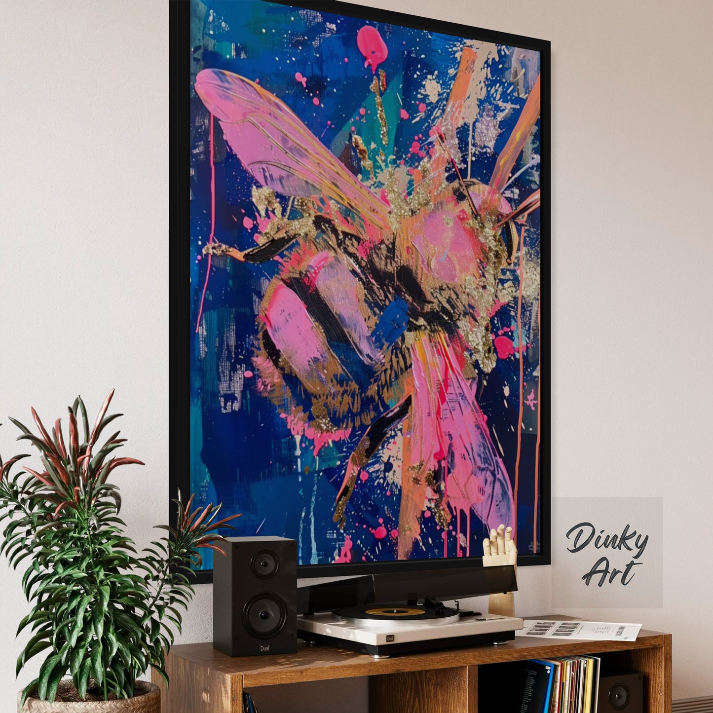 Colorful abstract art of a bee on a wall above a television.