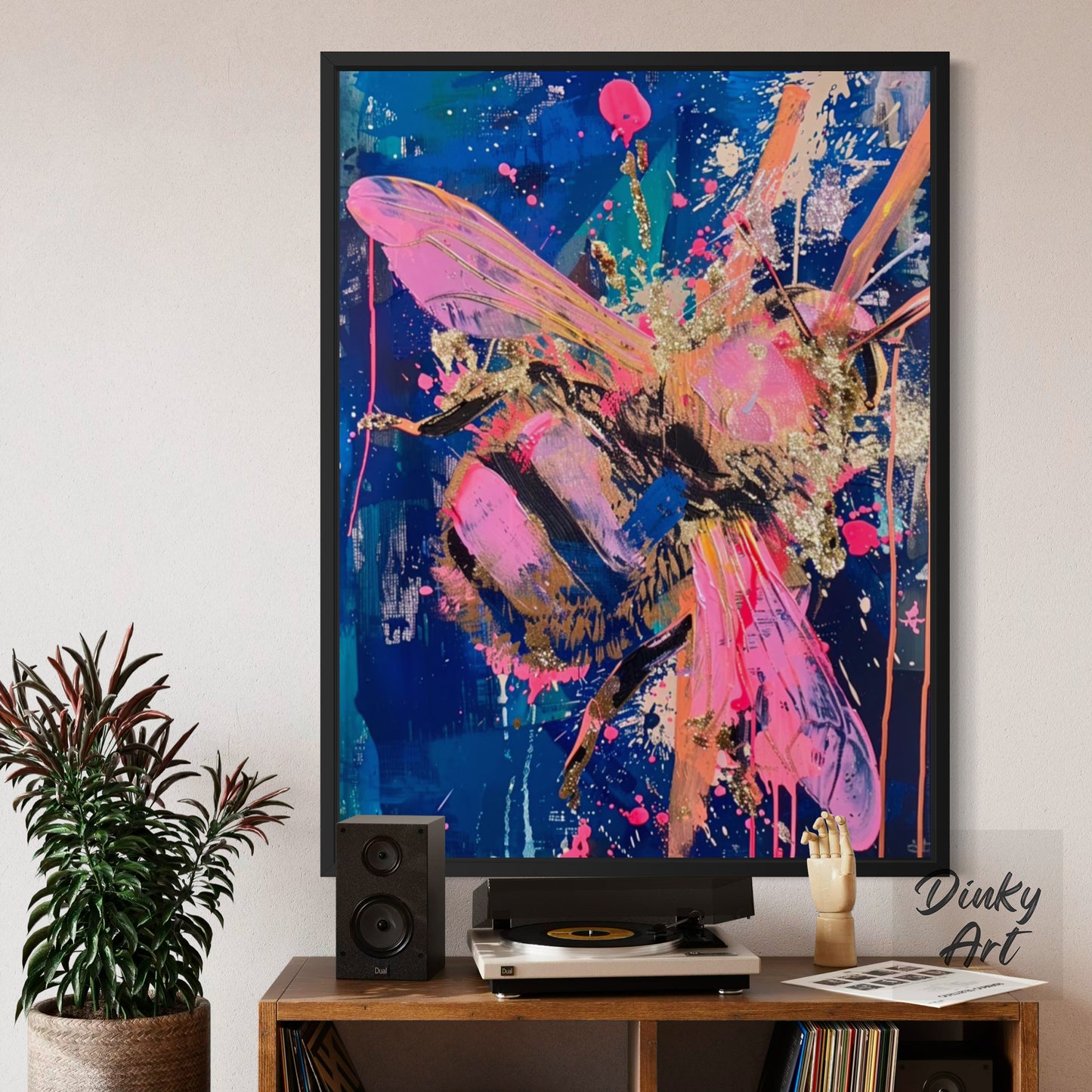 Abstract painting of a bee on a wall above a wooden shelf with decorative items.